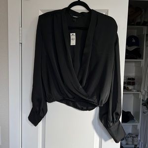 Black blouse. Clips in the front and has shoulder pads